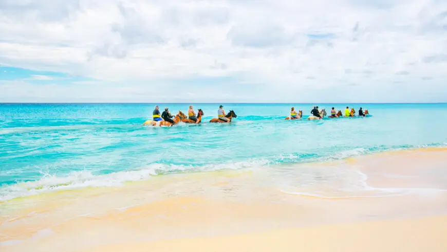 Why are the Turks and Caicos Islands ideal for horseback riding?